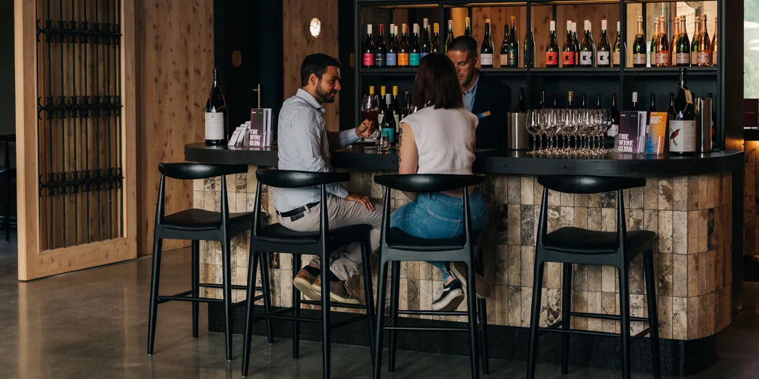 Couple tasting premium wines at the Kinross wine bar in Central Otago