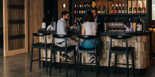 Couple tasting premium wines at the Kinross wine bar in Central Otago