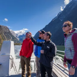 Group on a Milford Sound cruise listening to guide