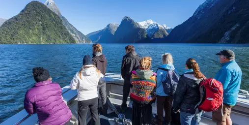 Group admiring Mitre Peak and alpine scenery from a Milford Sound cruise