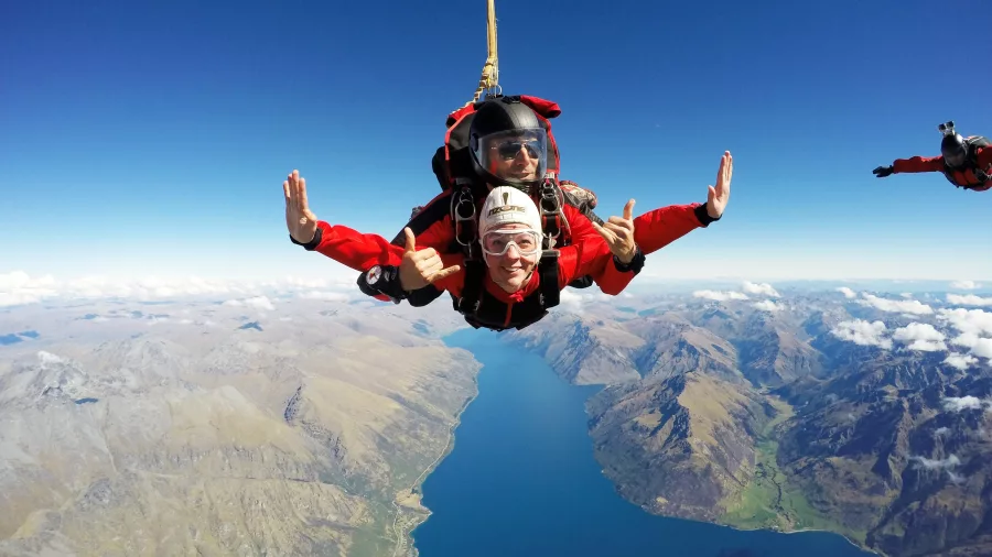 Tandem skydive with thumbs up over Lake Wakatipu, Queenstown