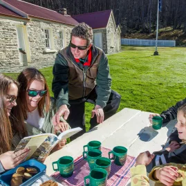 Tour group enjoying tea outside restored Skippers Schoolhouse