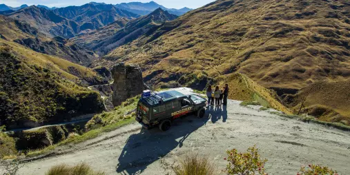 Tour group overlooking Skippers Canyon from a 4WD lookout stop