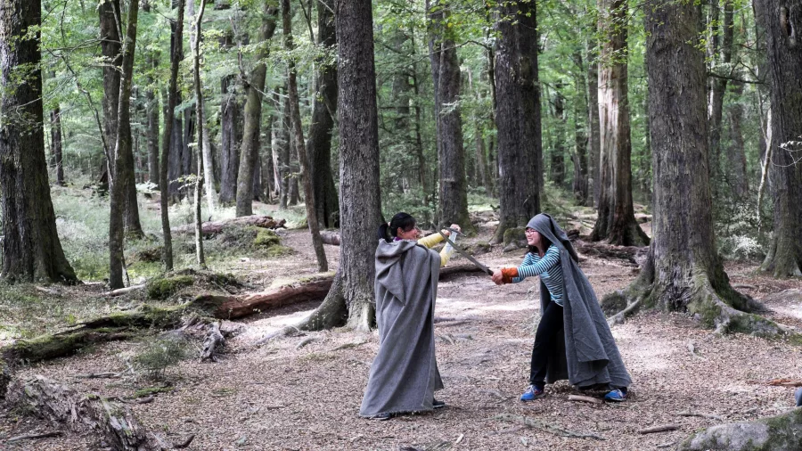 Tour guests sword fighting in a forest location used for Fangorn scenes
