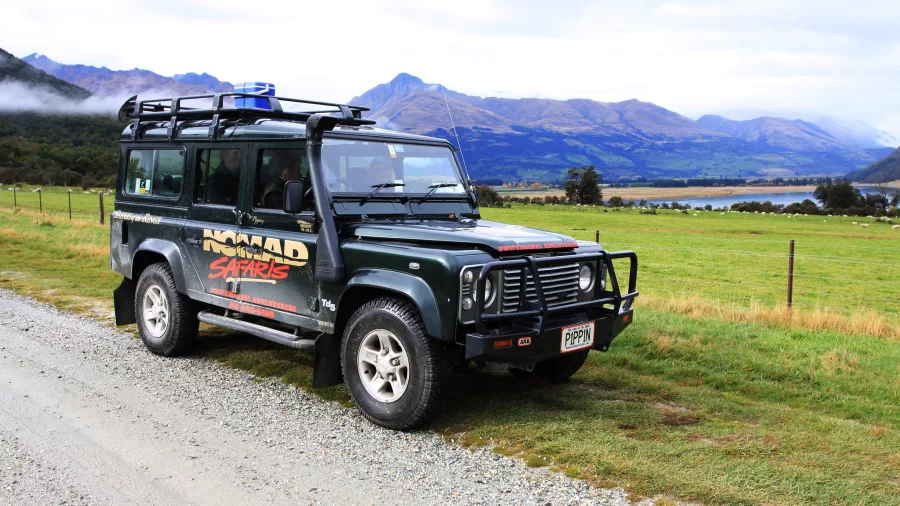 Nomad Safaris 4WD vehicle parked with lake and mountain views in Glenorchy