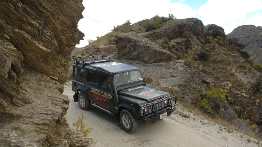 4WD vehicle navigating narrow canyon trail on LOTR Queenstown tour