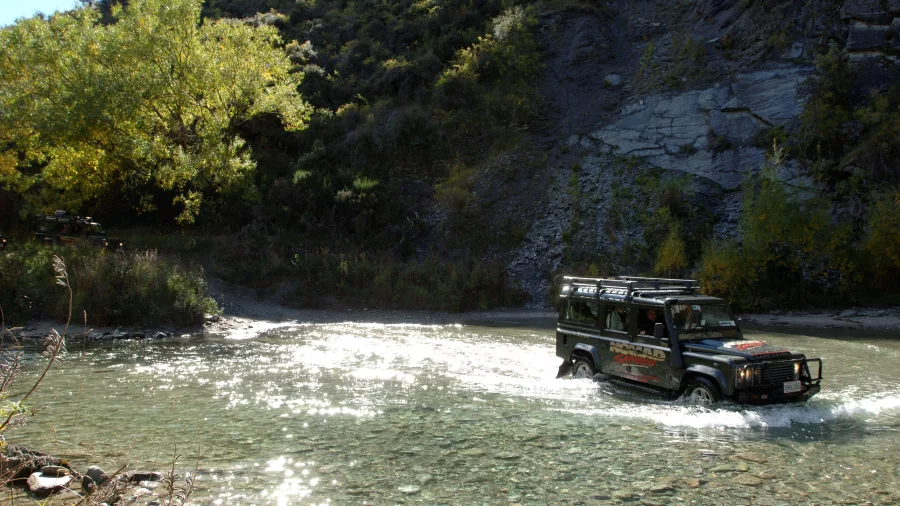 Nomad Safaris 4WD driving through river on Queenstown LOTR tour