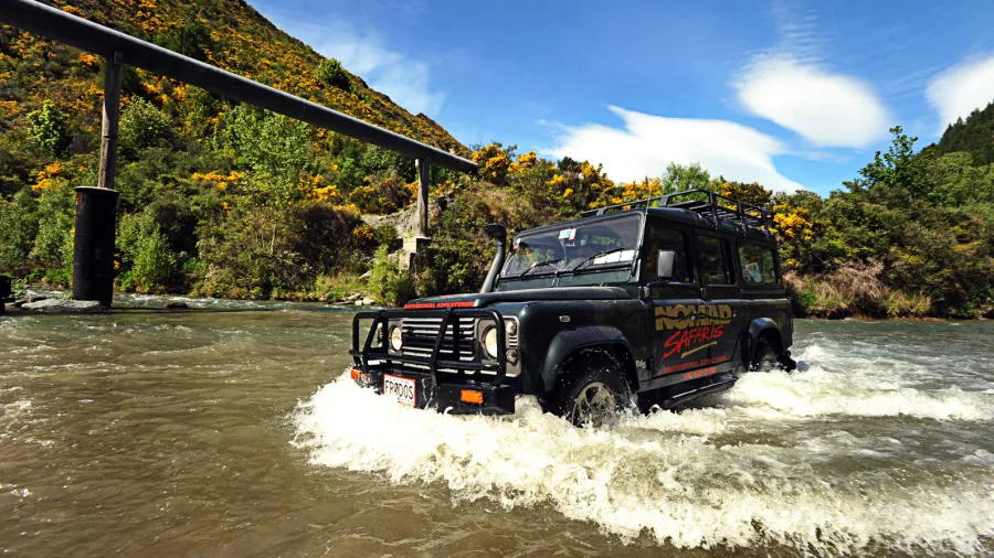 4WD vehicle driving through river at LOTR filming location near Queenstown