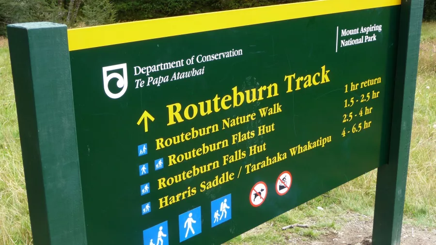 DOC Routeburn Track sign at trail entrance in Mt Aspiring National Park
