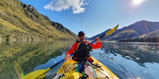Kayaker smiling on Moke Lake during guided tour