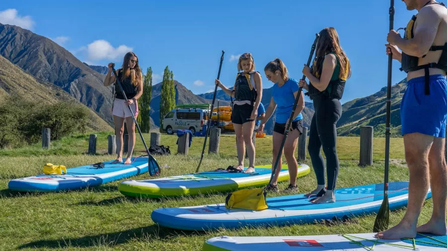 Group paddleboard lesson at Moke Lake with stunning alpine scenery in Queenstown