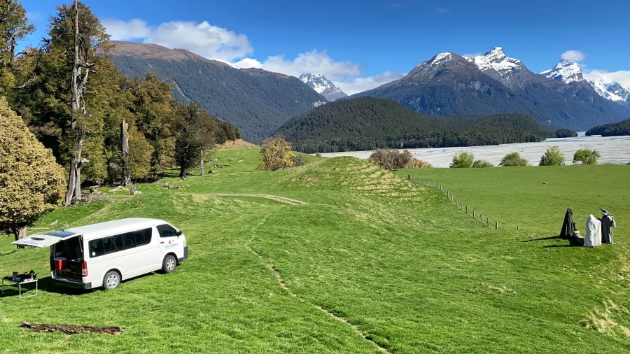 Pure Glenorchy tour van parked in the grassy meadows of Paradise with guests in costume