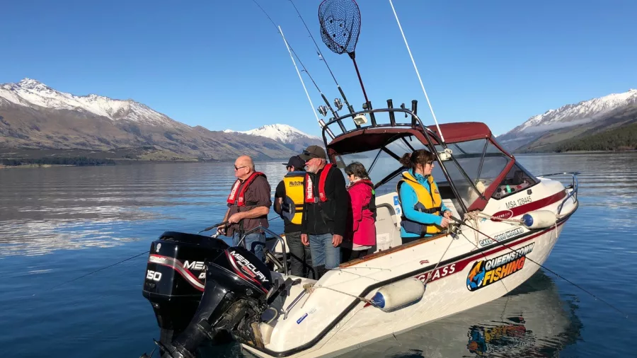 Group of people fishing from a Queenstown Fishing boat on Lake Wakatipu