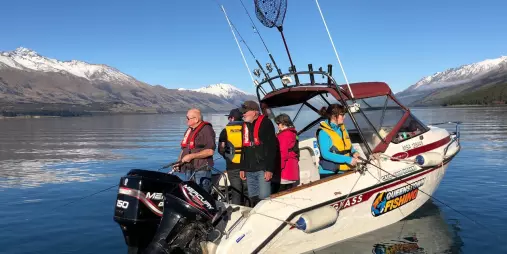Group of people fishing from a Queenstown Fishing boat on Lake Wakatipu