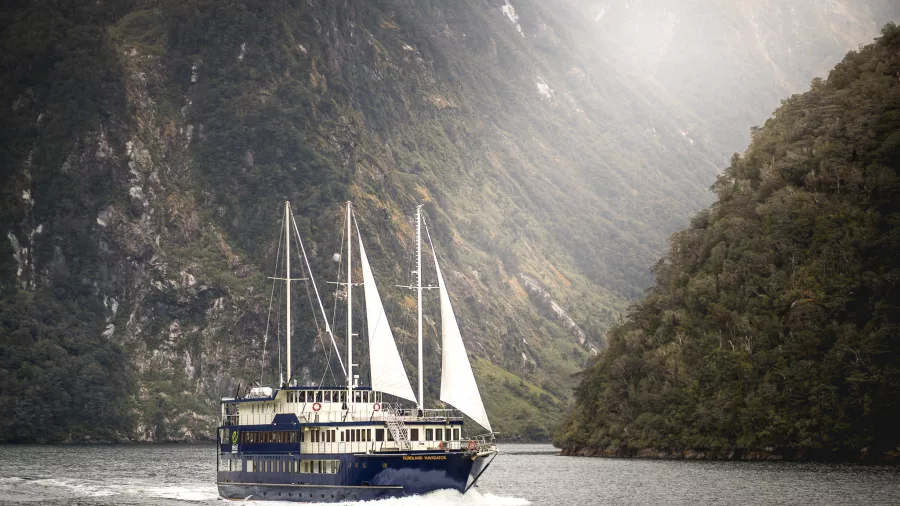 Fiordland Navigator sailing in Doubtful Sound with white sails raised