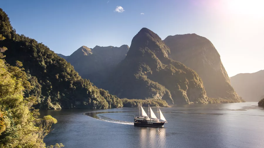 Panoramic view of the Fiordland Navigator cruising through remote Doubtful Sound