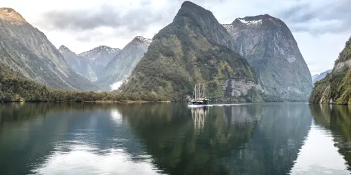 Fiordland Navigator cruising Doubtful Sound with mountain reflections