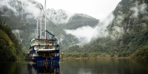 Fiordland Navigator moored in the still, misty waters of Doubtful Sound