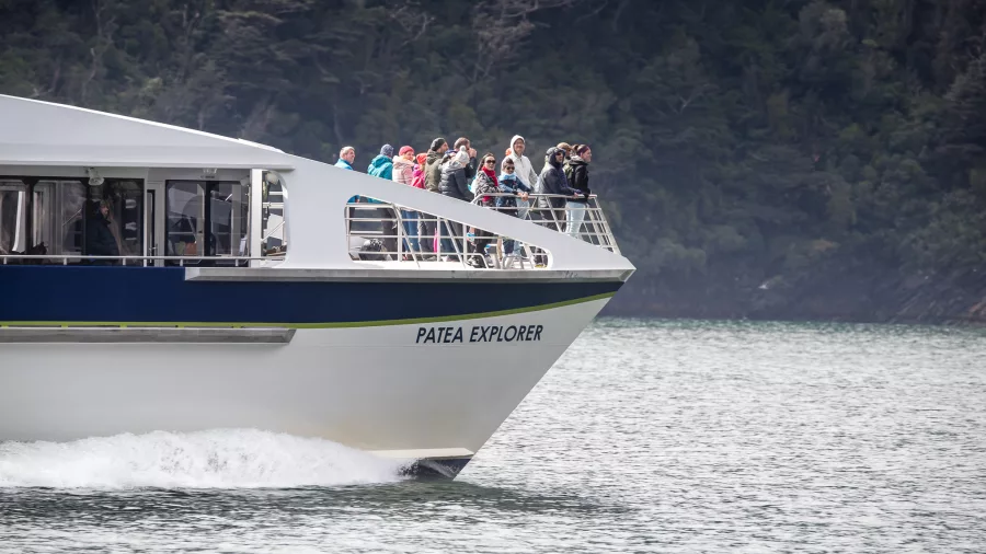 Close-up of passengers at the bow of the Patea Explorer enjoying the view in Doubtful Sound