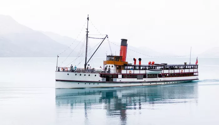 TSS Earnslaw sailing on calm waters of Lake Whakatipu in full daylight