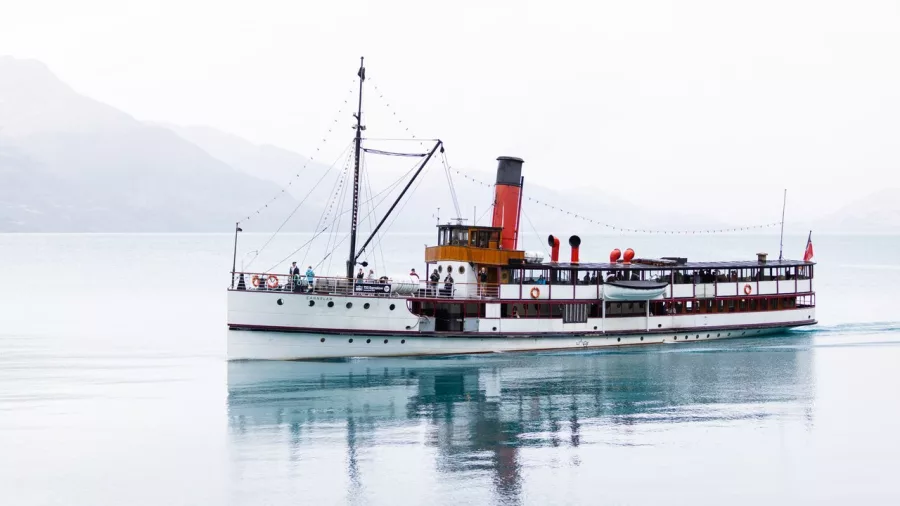 TSS Earnslaw sailing on calm waters of Lake Whakatipu in full daylight