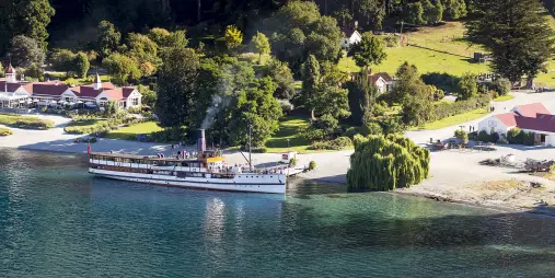TSS Earnslaw docked at Walter Peak with Queenstown hills behind