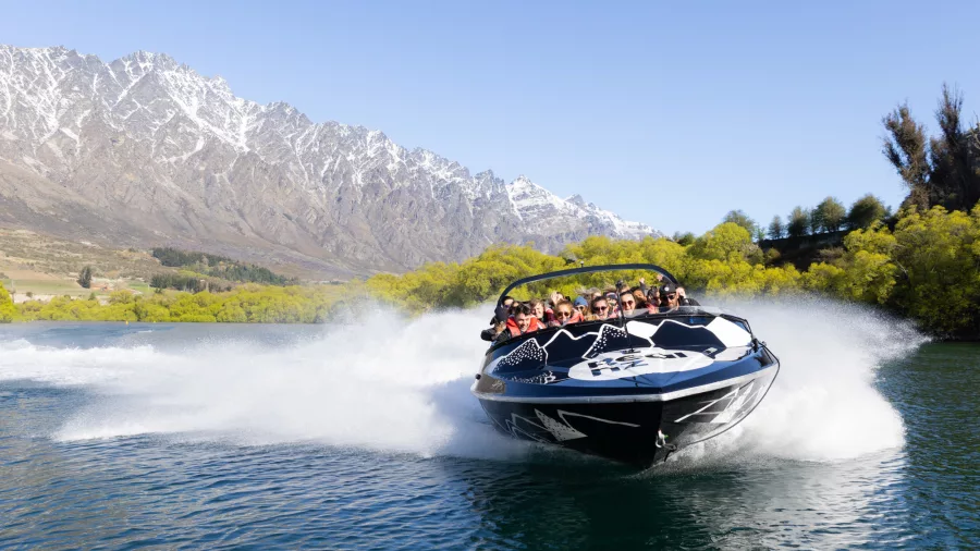 Jet boat cruising at the start of the Kawarau River adventure with The Remarkables in the background