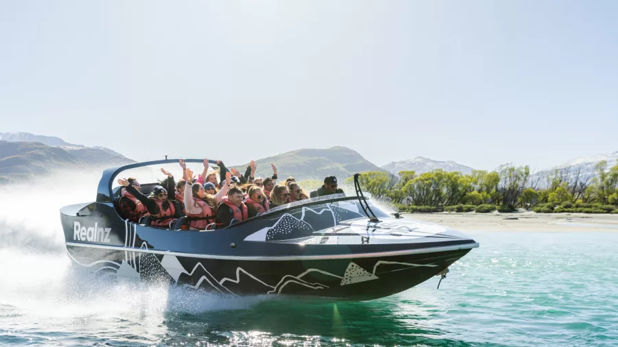 Group enjoying a scenic jet boat ride on Kawarau River in Queenstown