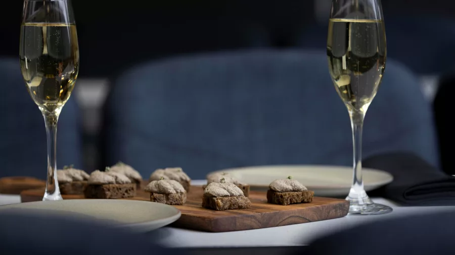 Elegant canapés and champagne glasses on board the Milford Sound Business Class Tour