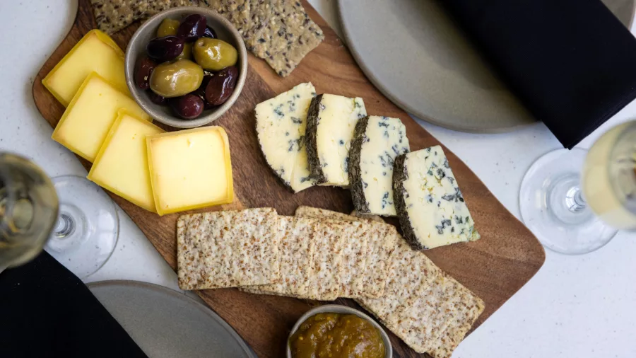 Artisan cheese and crackers served with olives and chutney