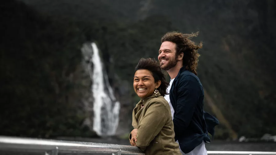 Smiling couple on deck with Stirling Falls in the background