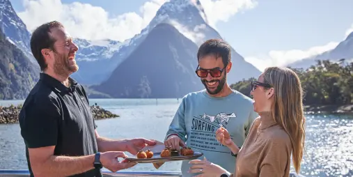 Guests enjoying canapes on milford cruise
