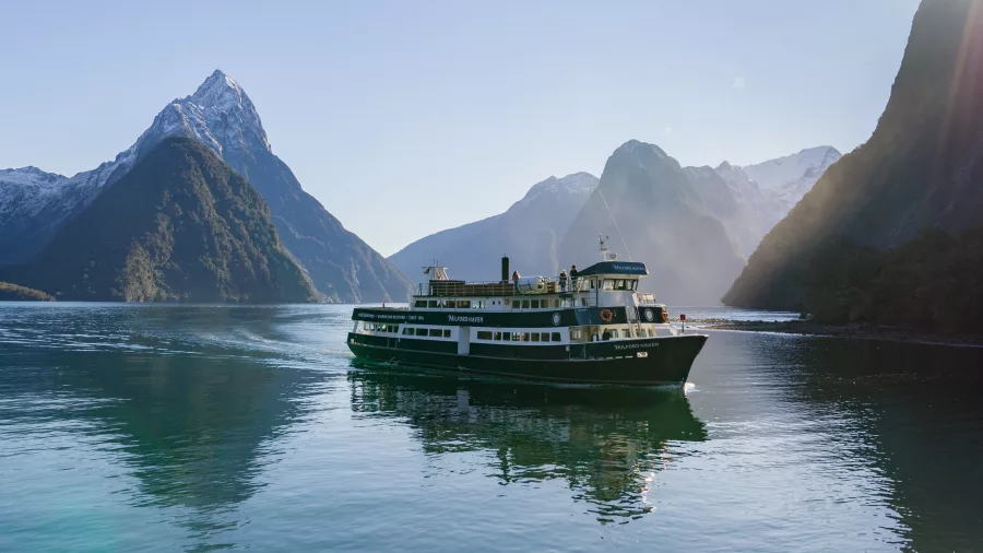 Milford Haven cruise ship with Mitre Peak and alpine scenery behind in Milford Sound