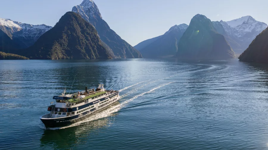 Milford Haven cruise boat sailing in front of Mitre Peak, Milford Sound