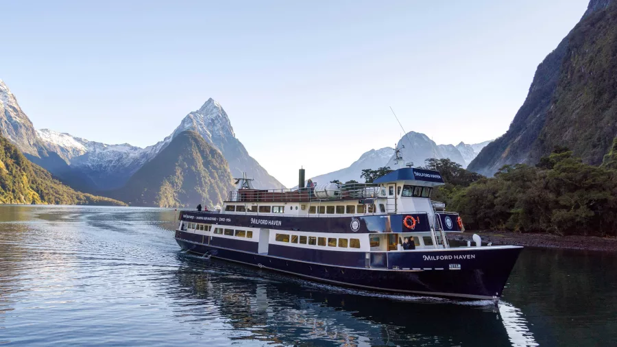 Milford Haven cruise ship sailing through Milford Sound with Mitre Peak in the background