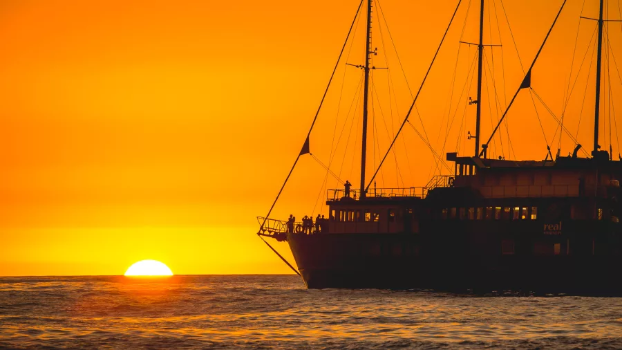 Silhouette of Milford Mariner at sea with the sun setting on the horizon