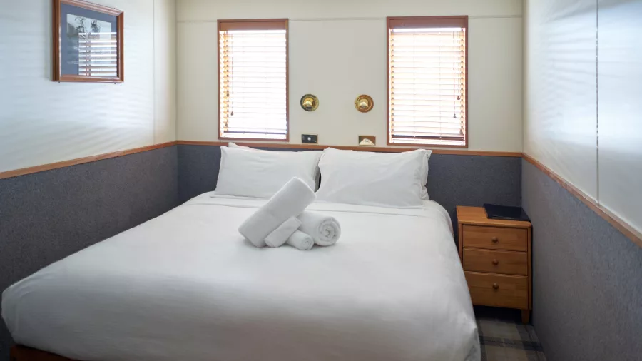 Bright double cabin with twin windows onboard Milford Mariner