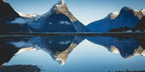 Perfect reflection of Mitre Peak in calm waters of Milford Sound