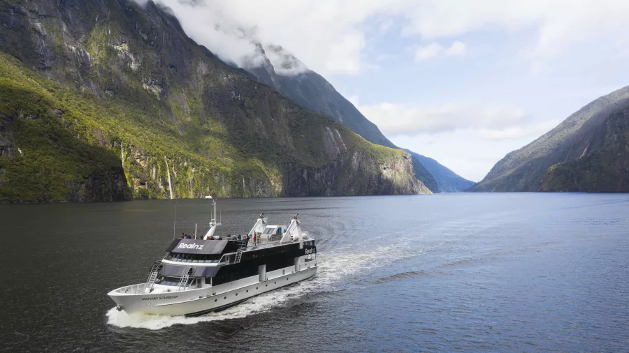 Milford Sovereign cruise boat sailing through Milford Sound on a scenic day tour