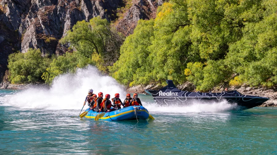 Jet boat speeding past a rafting group on the Kawarau River