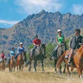 Guided horse trek near the Remarkables mountain range at Walter Peak Station, Queenstown, New Zealand