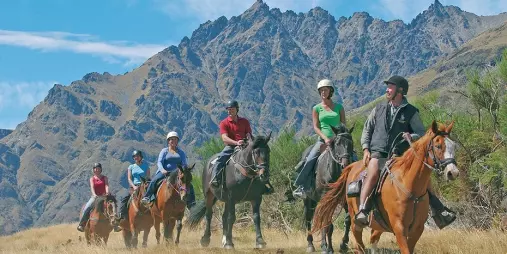 Guided horse trek near the Remarkables mountain range at Walter Peak Station, Queenstown, New Zealand