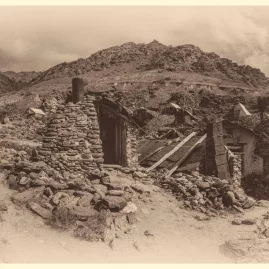 Sepia-toned view of historic Chinese gold miners' stone huts in Arrowtown