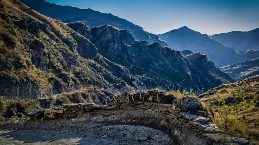 Scenic curve on Skippers Canyon Road with historic stone wall