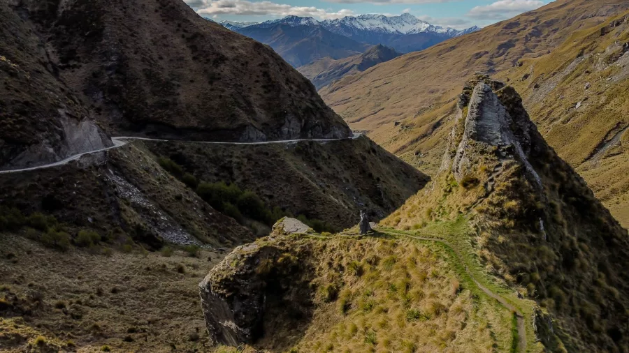 Tour group overlooking Skippers Canyon and The Lighthouse pinnacle on a Middle-earth tour near Queenstown, New Zealand
