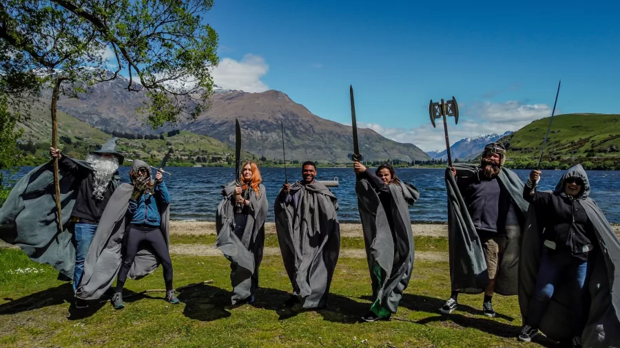 Guests in full costume posing with weapons in a LOTR scene near Queenstown