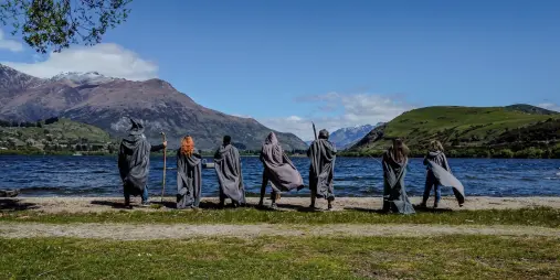 Group in Lord of the Rings costumes by Lake Whakatipu, recreating the Fellowship