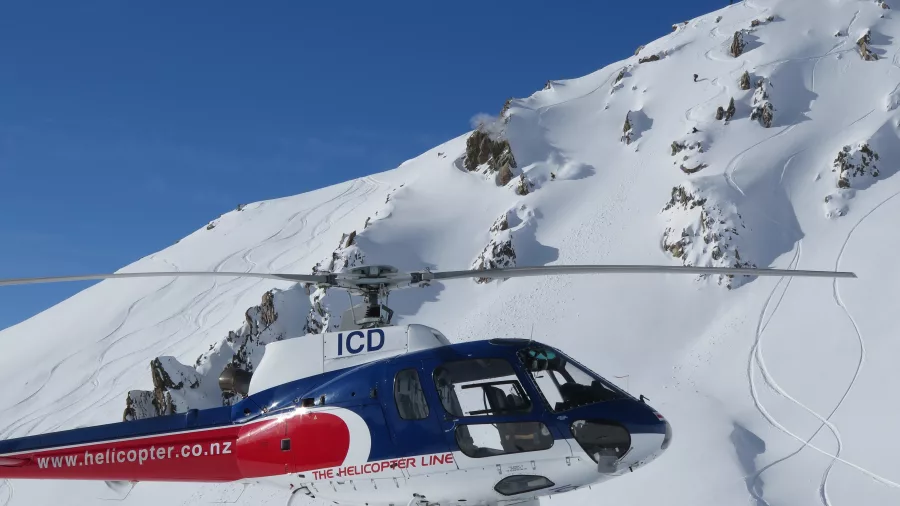 Helicopter landed on snowy glacier near Mount Cook