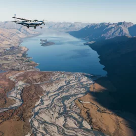 Aerial view of Lake Wakatipu and braided river systems with True South scenic flight