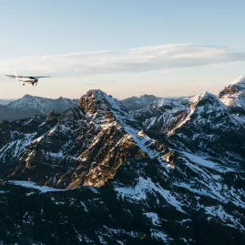 True South aircraft flying above jagged snowy Southern Alps mountain range